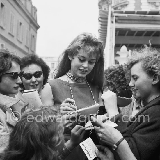 Brigitte Bardot signing autographs. Cannes Film Festival 1956. - Photo by Edward Quinn
