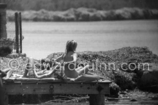Brigitte Bardot (right) pictured sun bathing near her home on Saint-Tropez in 1961. - Photo by Edward Quinn