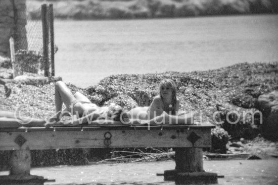 Brigitte Bardot (right) pictured sun bathing near her home on Saint-Tropez in 1961. - Photo by Edward Quinn