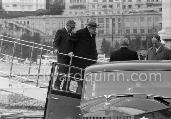 Sir Winston Churchill and Aristotle Onassis leaving yacht Christina. Far right Edmond Murray, (Churchill’s Scotland Yard bodyguard). Monaco harbor 1956. - Photo by Edward Quinn