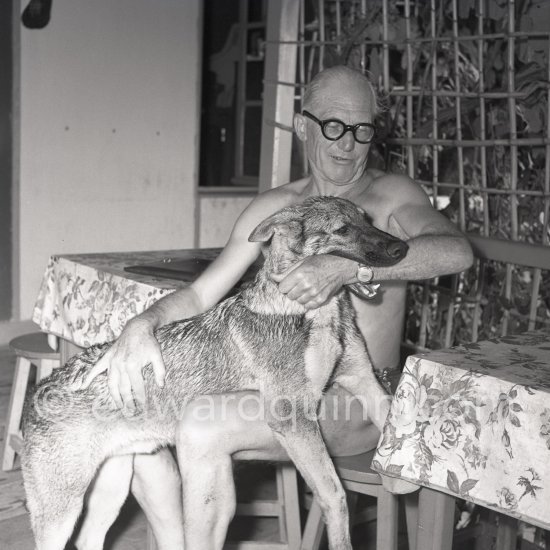 Le Corbusier (Charles-Édouard Jeanneret) with his dog at the small restaurant L\'Etoile de Mer attached to his vacation cabin Le Cabanon. Roquebrune-Cap-Martin 1953. - Photo by Edward Quinn