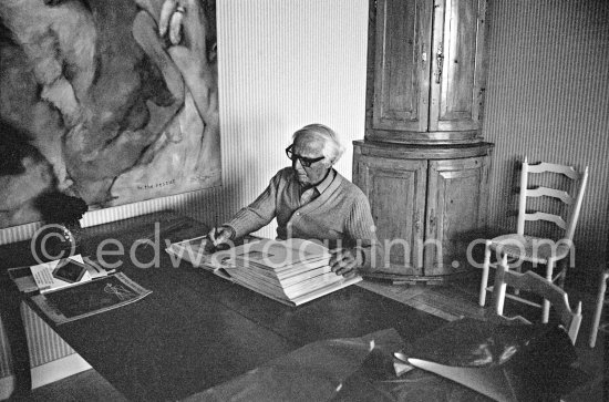 Max Ernst working on the mock-up of the book "Max Ernst" by Edward Quinn. Seillans 1975. - Photo by Edward Quinn