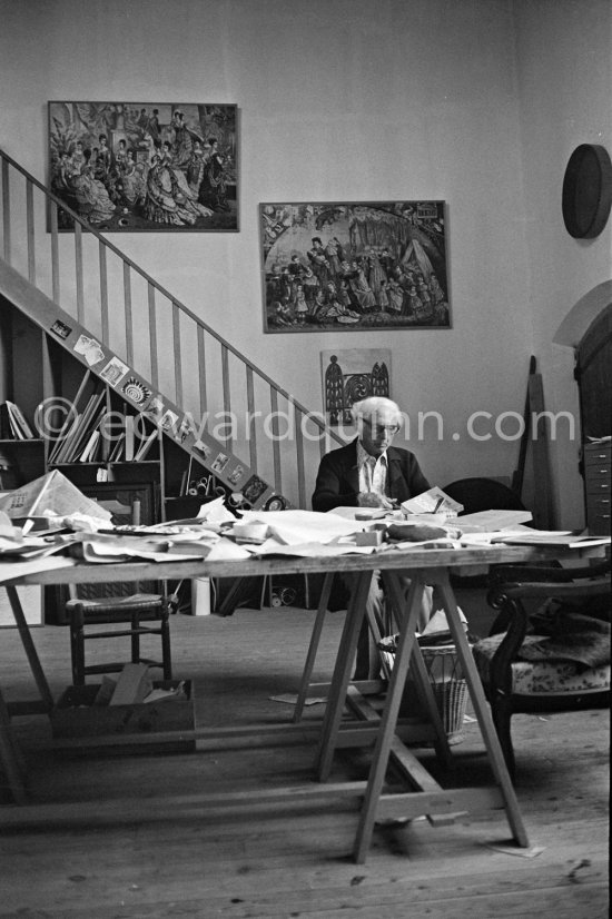 Max Ernst working on a collage at his studio. Seillans 1975. - Photo by Edward Quinn