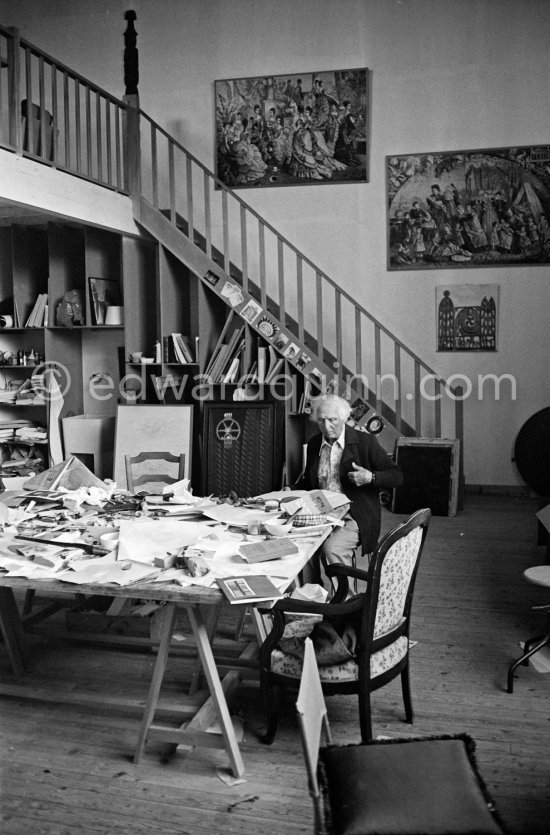 Max Ernst working on a collage at his studio. Seillans 1975. - Photo by Edward Quinn