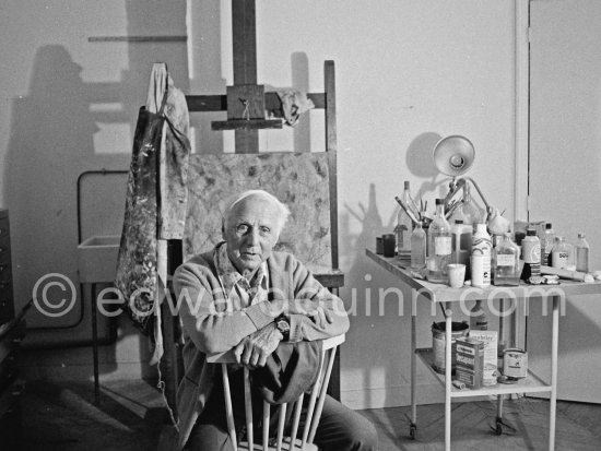 Max Ernst with his smock on the easel. Paris 1974. - Photo by Edward Quinn