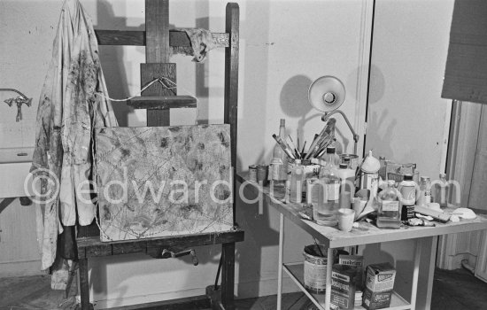 A corner of the studio of Max Ernst with his smock on the easel. Paris 1974. - Photo by Edward Quinn