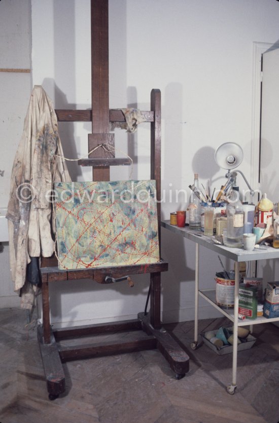 A corner of the studio of Max Ernst with his smock on the easel. Paris 1974. - Photo by Edward Quinn