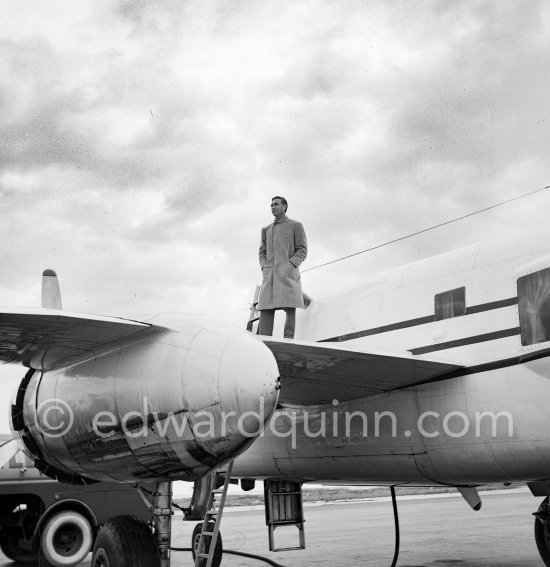 Porfirio Rubirosa on his private plane, a converted North American B-25 Mitchell, at Cannes Airport in 1954. North American B-25 Mitchell B-25H-1NA 43-4432 (N10V). See https://bit.ly/2XS08rs. Was as "Berlin Express" in the 1970 movie Catch-22. Today at Eagle Hangar, EAA Aviation Museum, Oshkosh. - Photo by Edward Quinn