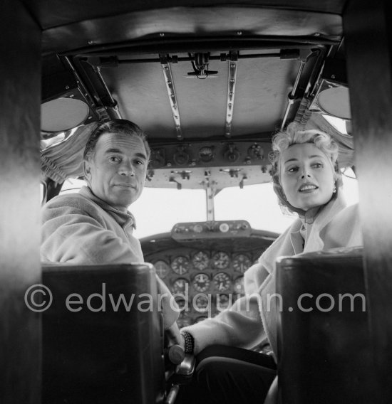 Zsa Zsa Gabor and Porfirio Rubirosa in the cockpit of his private plane, a converted North American B-25 Mitchell, at Cannes Airport in 1954. North American B-25 Mitchell B-25H-1NA 43-4432 (N10V). See https://bit.ly/2XS08rs. Was as "Berlin Express" in the 1970 movie Catch-22. Today at Eagle Hangar, EAA Aviation Museum, Oshkosh. - Photo by Edward Quinn