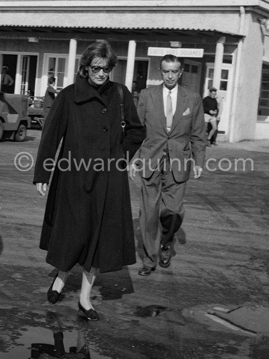 Greta Garbo with American businessman and boyfriend George Schlee (r) arriving at Nice Airport 1956. - Photo by Edward Quinn