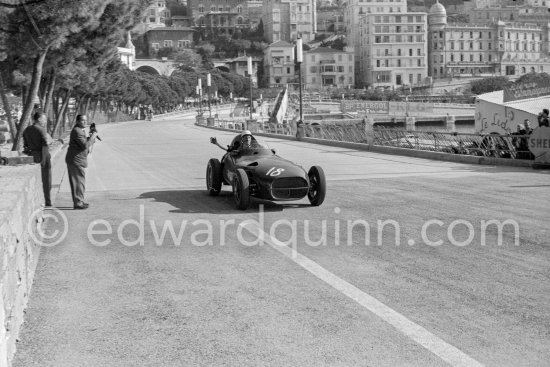 Stirling Moss, (18) Vanwall VW3/V4, with a wave comes back to the pits. Monaco Grand Prix 1957. - Photo by Edward Quinn