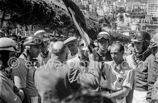 Driver\'s briefing, from left Maurice Trintignant, Juan Manuel Fangio, Harry Schell, Peter Collins, Wolfgang von Trips, Stirling Moss, Jack Brabham, Mike Hawthorn, Ivor Bueb. Monaco Grand Prix 1957. - Photo by Edward Quinn