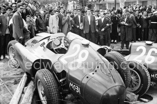 After the race: The cars of Mike Hawthorn, (28) Ferrari-Lancia D50 and Peter Collins, (26) Ferrari 801 in the barriers while Wolfgang von Trips, (24) Ferrari 80I, passes. The incident happend in lap 4 of the 1957 Monaco Grand Prix after leader Stirling Moss "lost" his Vanwall in the chicane. Peter Collins swerved to avoid Moss but hit the wall while Mike Hawthorn rammed Tony Brooks who braked hard to avoid the cars in front of him. - Photo by Edward Quinn