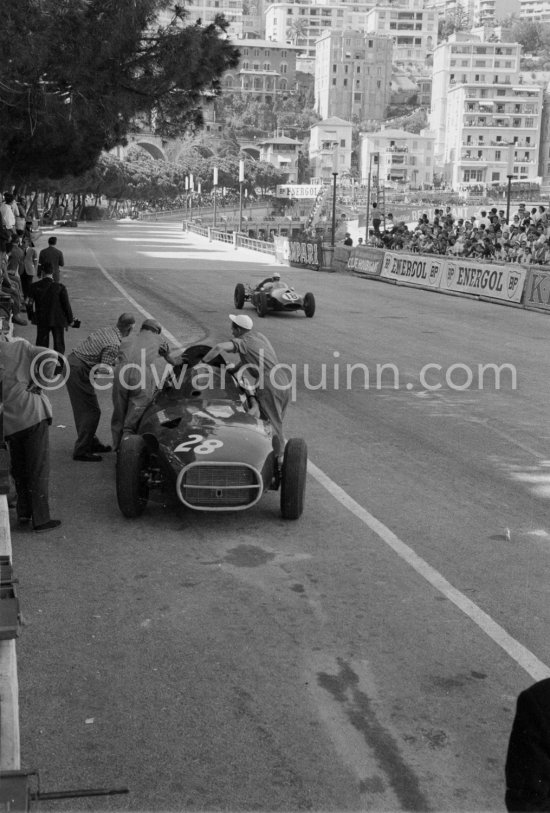 Stirling Moss, (28) Vanwall VW7, stops at the pits with valve problems. Tony Vandervell (white hat), founder of the Vanwall Formula One racing team. Monaco Grand Prix 1958. - Photo by Edward Quinn