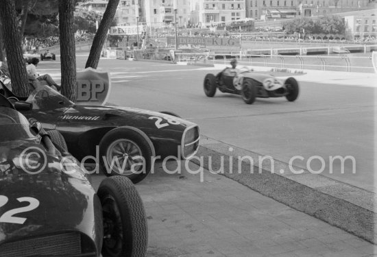 Stranded Vanwalls of Stirling Moss\' (28) and Stuart Lewis-Evans\' (32). Cliff Allison, (24), passes in Lotus 12. Monaco Grand Prix 1958. - Photo by Edward Quinn