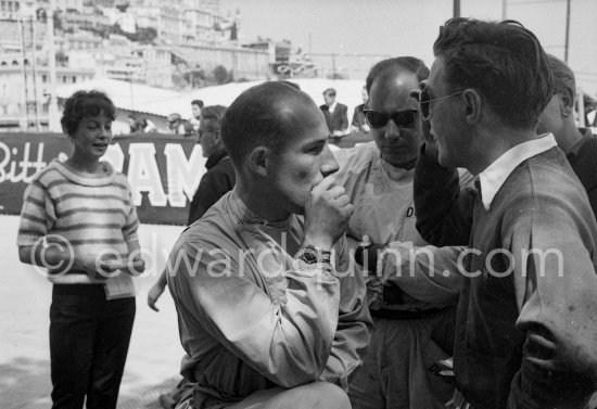 As Stirling Moss, Ivor Bueb and Ron Flockhart (r) chat, Katie Moss remains in the background. Monaco Grand Prix 1959. - Photo by Edward Quinn