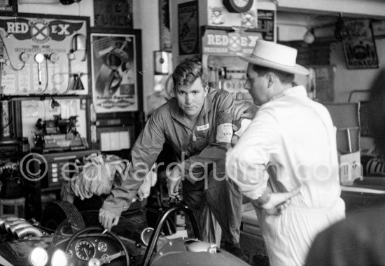 In a backstreet garage of Monte Carlo, Lance Reventlow, the driver-owner-constructor of Scarab cars talks with Jack Brabham. Monaco Grand Prix 1960. - Photo by Edward Quinn