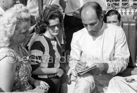 Stirling Moss signing autographs. Monaco Grand Prix 1960. - Photo by Edward Quinn