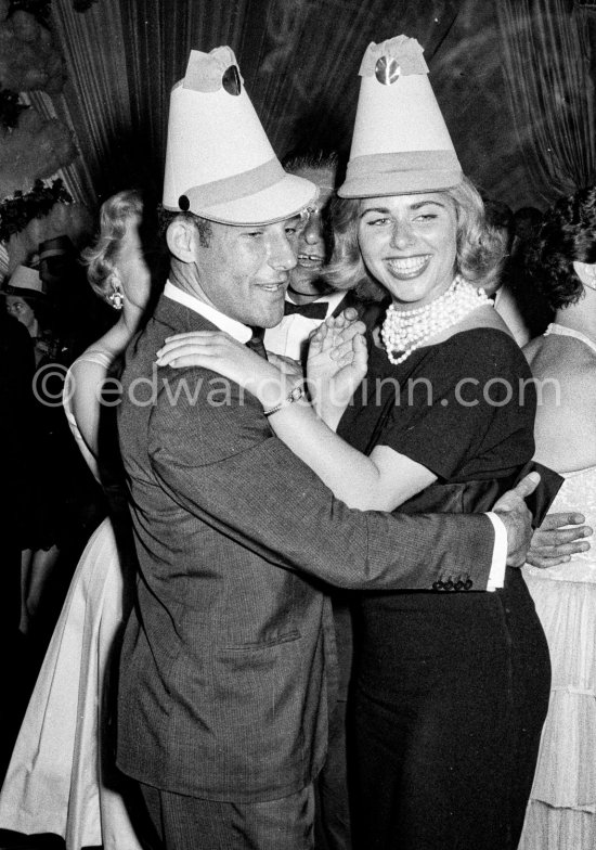 Stirling Moss, winner of the Grand Prix, gets into the party spirit with paper hat and cha-cha as he dances with Swedish model Helga Mayerhoffer. Gala of Monaco Grand Prix 1960. - Photo by Edward Quinn
