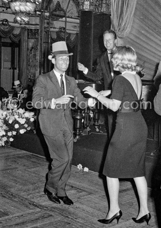 Stirling Moss, winner of the Grand Prix, gets into the party spirit as he dances with Swedish model Helga Mayerhoffer. Maestro Louis Frosio in the background. Gala of Monaco Grand Prix 1960. - Photo by Edward Quinn