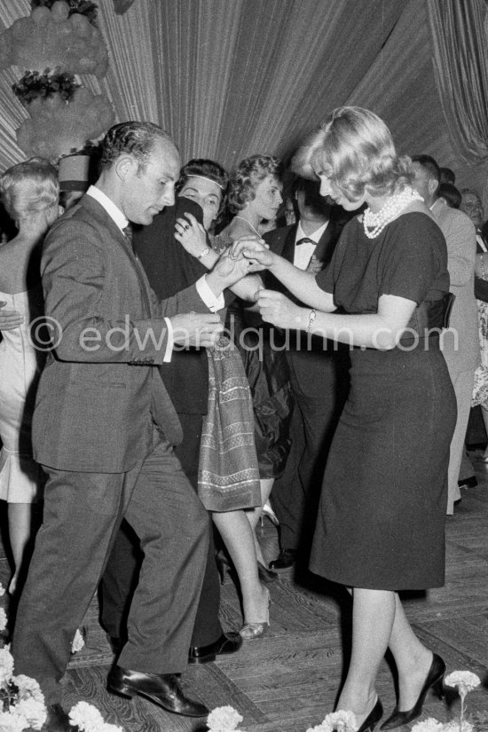 Stirling Moss, winner of the Grand Prix, gets into the party spirit as he dances with Swedish model Helga Mayerhoffer. Gala of Monaco Grand Prix 1960. - Photo by Edward Quinn