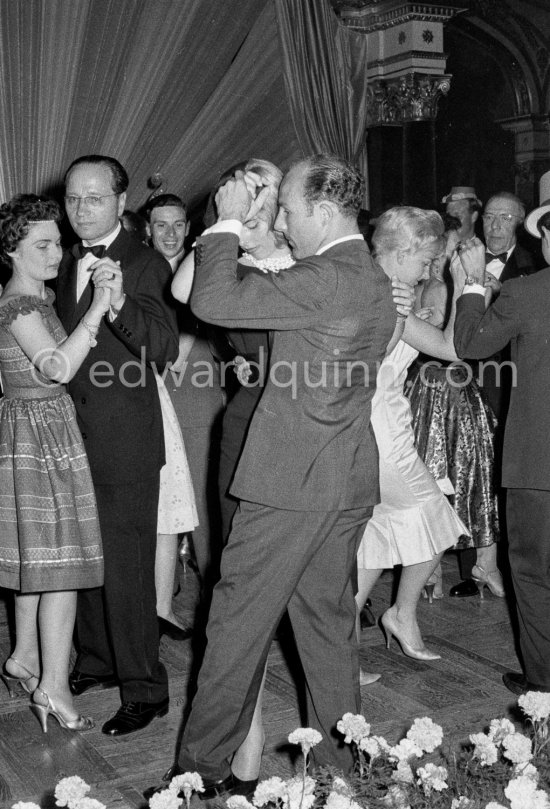 Stirling Moss, winner of the Grand Prix, gets into the party spirit as he dances with Swedish model Helga Mayerhoffer. Jim Clark in the background. Gala of Monaco Grand Prix 1960. - Photo by Edward Quinn