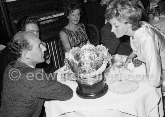 Stirling Moss with his silver cup after the race with Shirley Adams, his American friend. Monaco Grand Prix 1961. - Photo by Edward Quinn