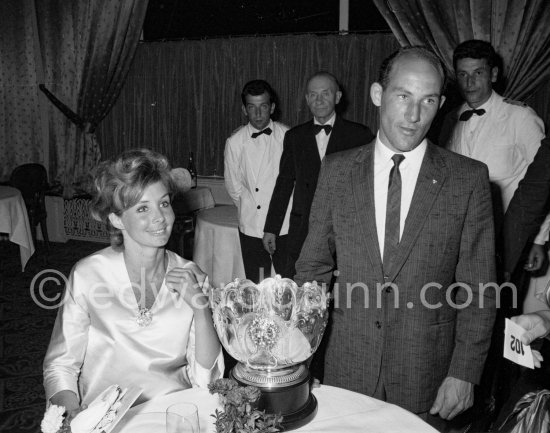 Stirling Moss with his silver cup after the race with Shirley Adams, his American friend. Monaco Grand Prix 1961. - Photo by Edward Quinn