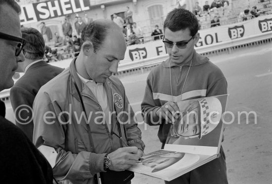 Signing autographs: Stirling Moss, commentates for ABC Wide World of Sport. Monaco Grand Prix 1964. - Photo by Edward Quinn