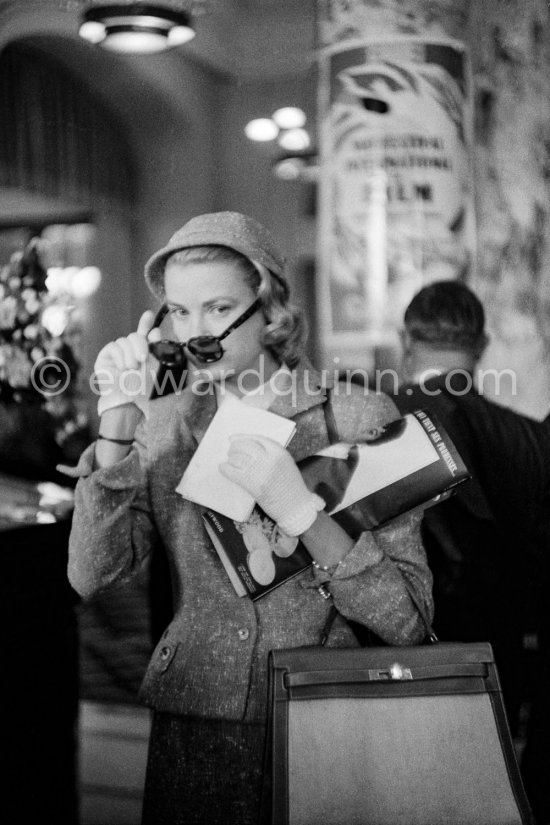 Grace Kelly with the original Kelly Bag arriving at Cannes station 1955. - Photo by Edward Quinn