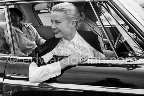 Grace Kelly, Cannes Film Festival 1955. On the backseat Gladys de Segonzac, costume designer. Jewellery: Cartier Trinity ring. Car: 1955 Studebaker Commander - Photo by Edward Quinn