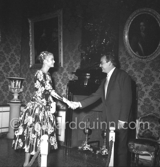 Grace Kelly Grace Kelly (later to become Princess Grace) meets Prince Rainier at the Royal Palace. The historic moment of the first formal handshake. Their smile seems to show an instant contact and already a mutual esteem. Monaco 1955. - Photo by Edward Quinn
