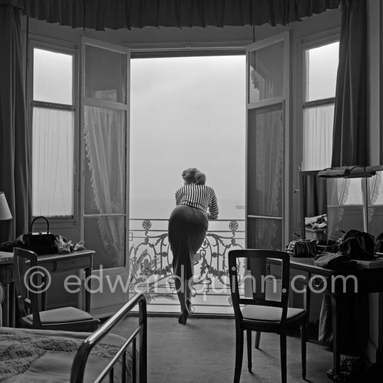 A privileged view: Sophia Loren looking out at the sea from her room in the Carlton Hotel. Cannes Film Festival 1955. - Photo by Edward Quinn