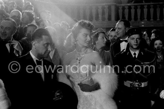 Sophia Loren, wearing an evening gown designed by Emilio Schuberth, making her entry to the Palais du Festival. Paolo Stoppa on the left. Cannes 27 April 1955. - Photo by Edward Quinn