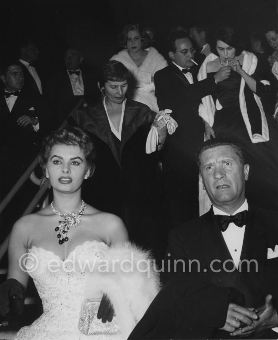 Sophia Loren and Paolo Stoppa. Silvana Mangano smoking in the background right. 27 April 1955. - Photo by Edward Quinn