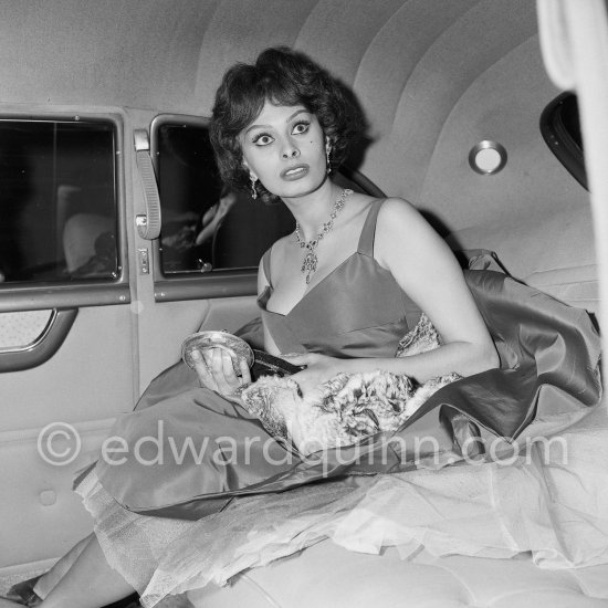 Sophia Loren apparently quite amazed, holding a lemon squeezer in her hand. Cannes Film Festival 1958. - Photo by Edward Quinn