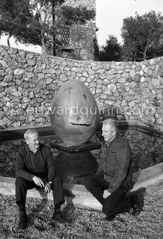 Juan Miró  and Aimé Maeght in the gardens of Musée Maeght in front of a small pool with an "Oeuf cosmique" by Miró  in center. Saint-Paul-de-Vence 1964. - Photo by Edward Quinn