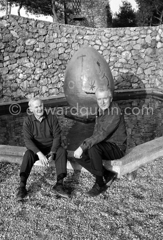 Joan Miró and Aimé Maeght in the gardens of Musée Maeght in front of a small pool with an "Oeuf cosmique" by Miró in center. Saint-Paul-de-Vence 1964. - Photo by Edward Quinn