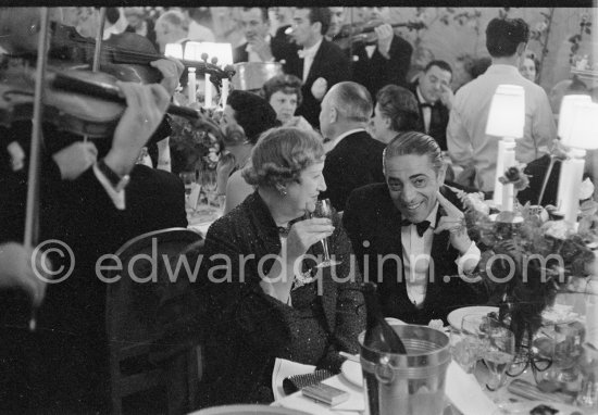 Aristotle Onassis and his guest Mrs Jacks. "Bal de la Rose" gala dinner at the International Sporting Club in Monte Carlo, 1956. - Photo by Edward Quinn