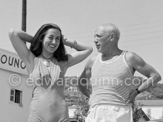 Pablo Picasso and Françoise Gilot in front of restaurant Nounou. She wears a pendant by Pablo Picasso. At the beach of Golfe-Juan 1954. - Photo by Edward Quinn