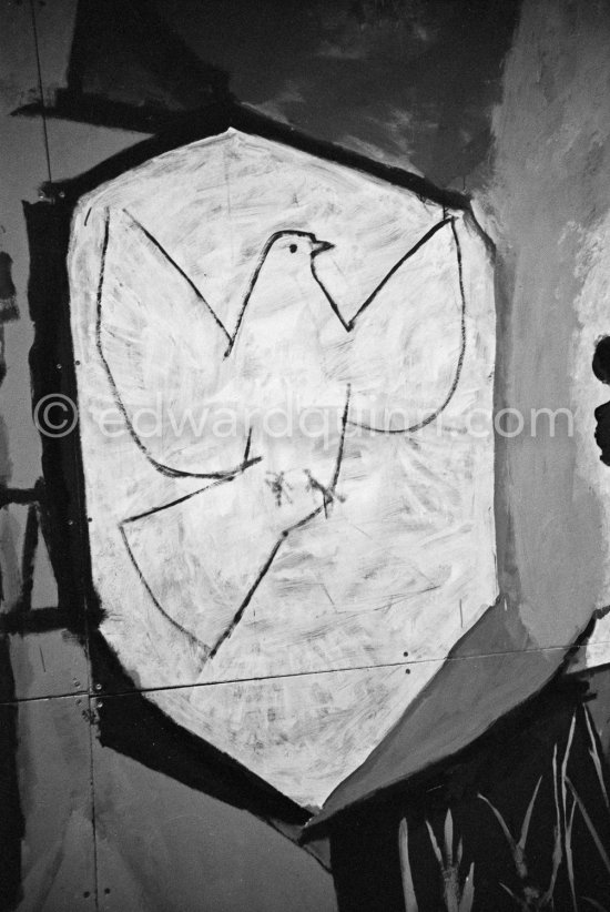 War and Peace ("La Guerre et la Paix") drawing on the vault of the Temple of Peace (Temple de la Paix, or Chapelle de la paix). A dove of peace, superimposed on the face of Françoise Gilot, on a shield of a young man. Vallauris 1961. - Photo by Edward Quinn