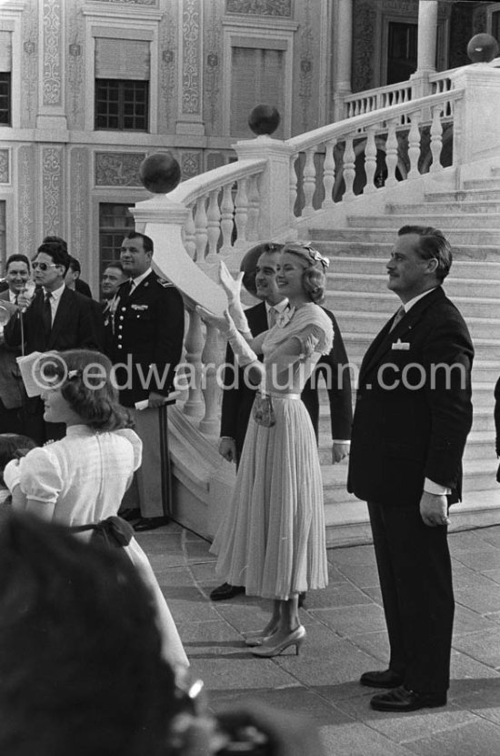 Prince Rainier and Princess Grace  meeting Monegasque people in the courtyard of the Royal Palace, Monaco 1956 for the official reception of the wedding presents. Grace Kelly wore a pale blue chiffon day dress by the California designer James Galanos. She accessorized z^the dress with a small headpiece of matching blue ribbon, white gloves and the same Morabito needlepoint bag she had carried to the Academy Award of 1955. - Photo by Edward Quinn