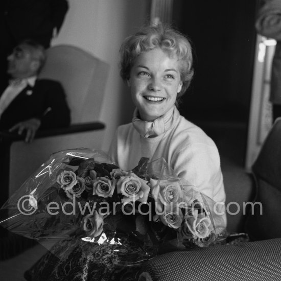 Romy Schneider, with a bunch of the very special crimson roses produced by the leading rose specialist, M. Meilland, christened the "Sissi Cocktail" in her honour. Cannes Film Festival 1957. - Photo by Edward Quinn