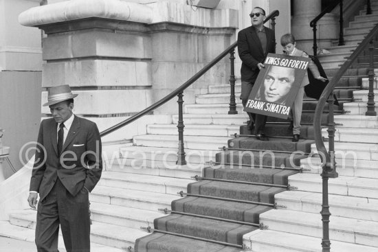 Frank Sinatra in Monaco in 1958 to perform at a charity gala evening at the Sporting d’Eté for the UN Refugees children. Behind him a sandwich boy with a poster for the film "Kings Go Forth", which was made in Monaco and Roquebrune the year before. - Photo by Edward Quinn