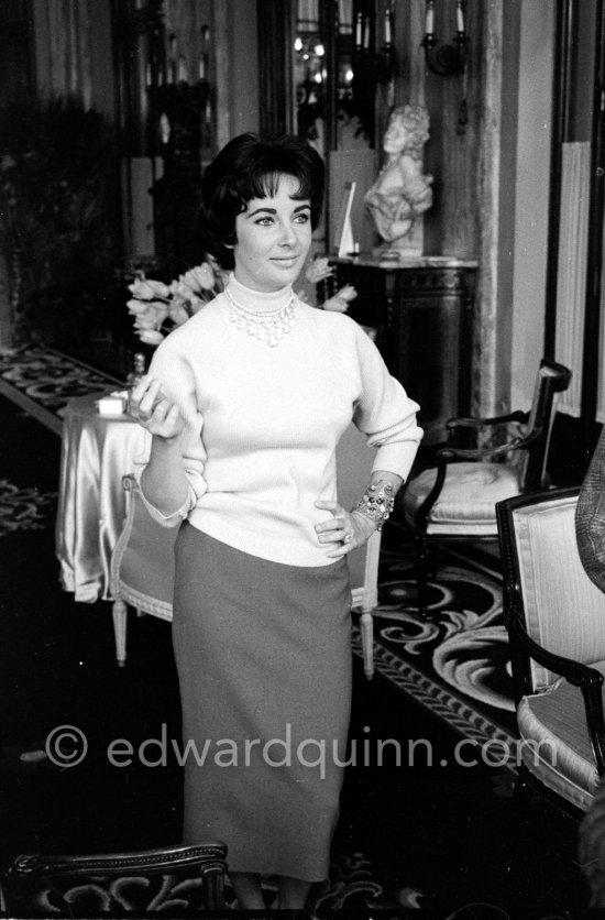 Attended by Cartier jewellers Liz Taylor tries on a beautiful diamond necklace with matching earrings she spotted while window-shopping in Monte Carlo with her third husband Mike Todd. At $500,000, the necklace was beyond Todd’s budget, but the earrings were her consolation prize. Monte Carlo 1958. - Photo by Edward Quinn