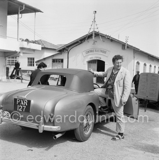 Peter Ustinov in sporting outfit at the film Studios of Nice where he worked for the English version of "Lola Montès". Nice 1955. Car: 1955 Aston Martin DB 2/4 Drophead coupé - Photo by Edward Quinn