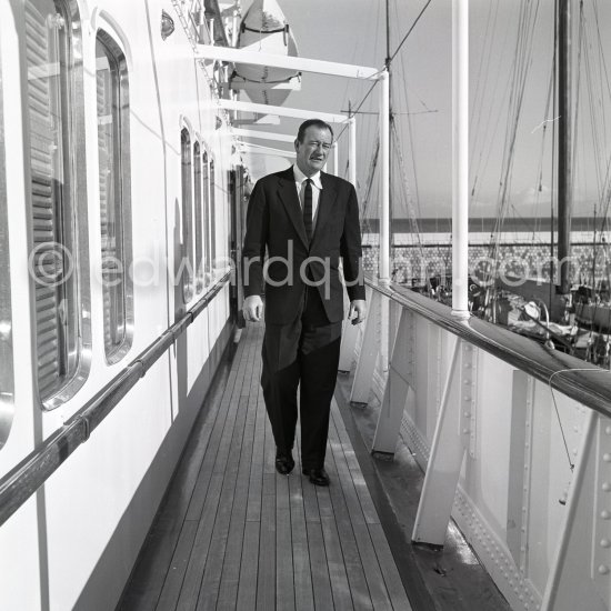 John Wayne on board Onassis\' yacht Christina. Monaco harbor 1955. - Photo by Edward Quinn