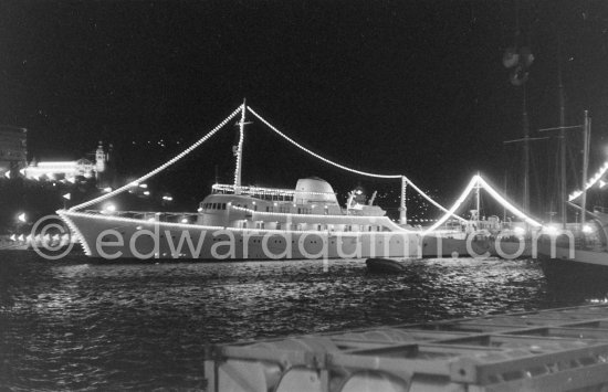 Yacht Christina of Aristotle Onassis lit up in harbor. Monaco 1960. - Photo by Edward Quinn