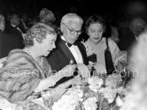 Charlie Chaplin surrounded by friends at the Figaro Gala in Cannes 1953. - Photo by Edward Quinn