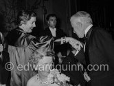 Charly Chaplin, greeting Florence Gould (a former dancer at the Folies Bergères,), whose husband Frank Jay Gould was regarded as the "founder" of Juan-les-Pins. Figaro Gala. Cannes 1953. - Photo by Edward Quinn